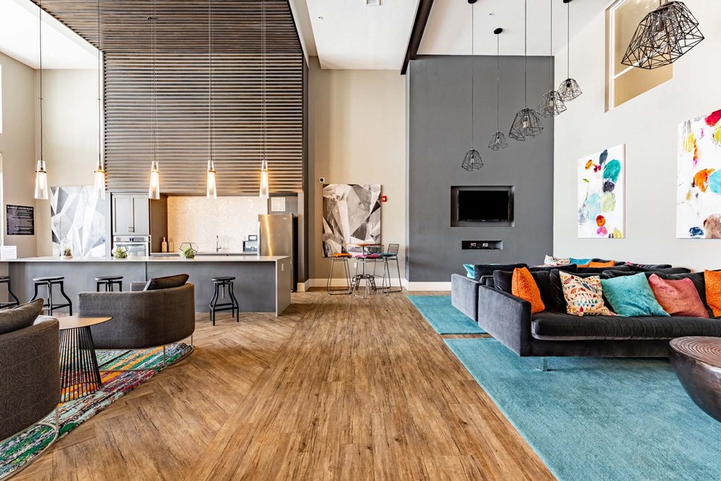 a living room with a couch and a kitchen at Linden on the GreeneWay, Florida, 32824