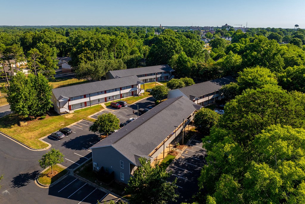 a view from above of a building with a parking lot and trees a view from above of a building with a parking lot and trees at Ashford Place Apartments, Kannapolis, NC 28081