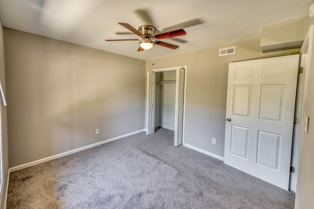 a bedroom with carpet and a ceiling fan a bedroom with carpet and a ceiling fan at Ashford Place Apartments, North Carolina, 28081