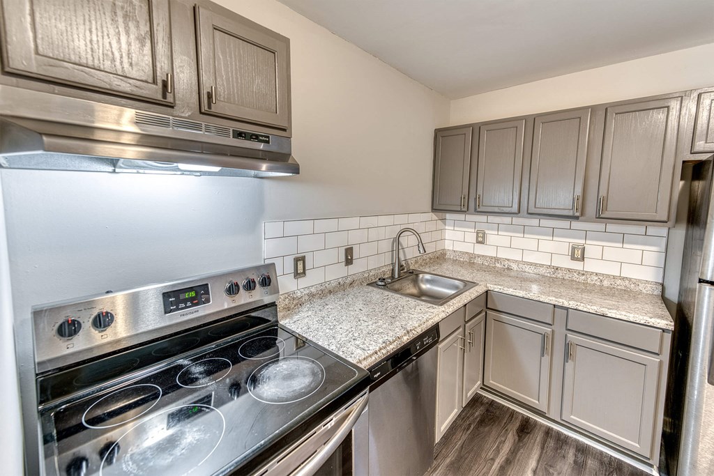 a kitchen with stainless steel appliances and granite counter tops at Ashford Place Apartments, Kannapolis North Carolina