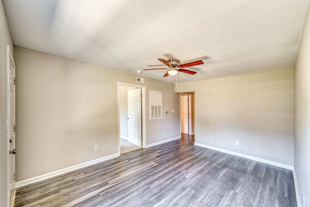 a living room with wood floors and a ceiling fan a living room with wood floors and a ceiling fan at Ashford Place Apartments, Kannapolis, NC 28081
