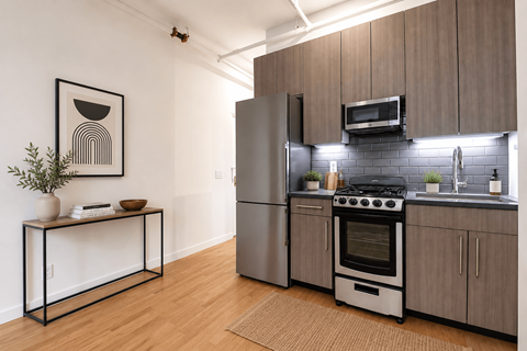 A modern kitchen with a stove top oven and a refrigerator.