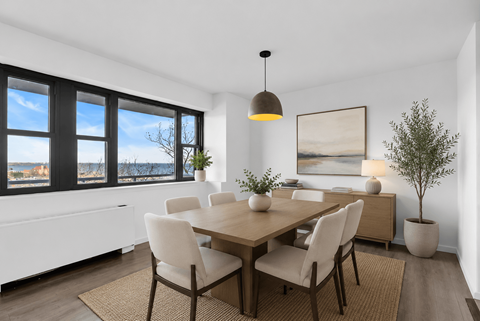 A dining room with a table set for four.