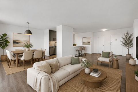 A living room with a white couch and a coffee table.