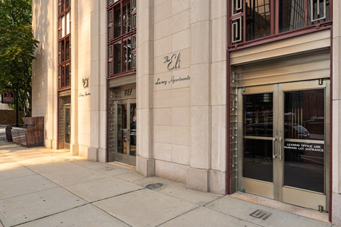 The entrance to a building with a glass door and a sign that reads "Learning Office Line.".