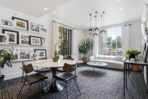 A modern living room with a round table and chairs.