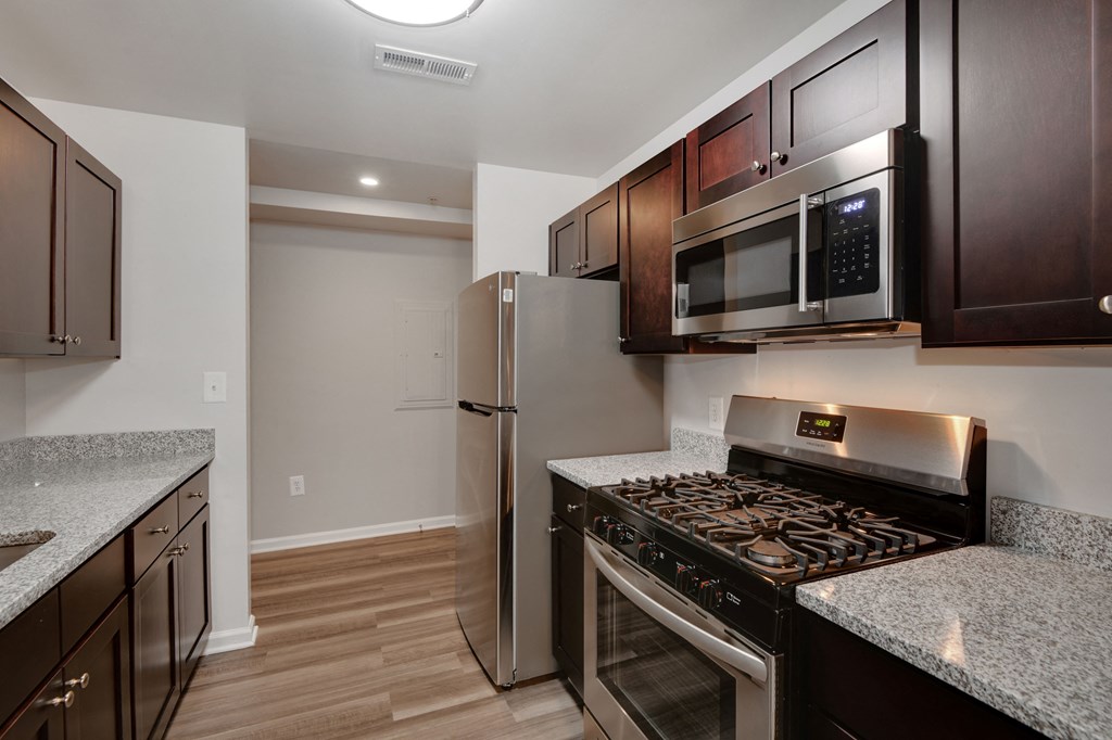 a kitchen with stainless steel appliances and granite counter tops and