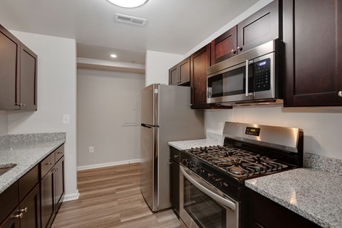 a kitchen with stainless steel appliances and granite counter tops and