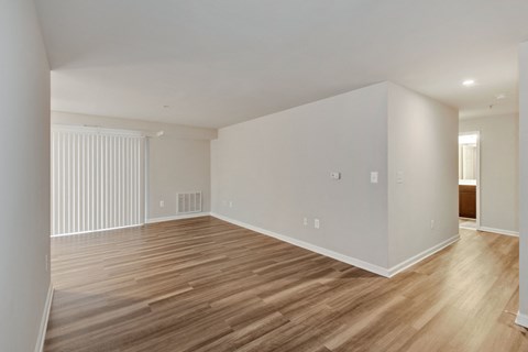 a living room with wood floors and white walls