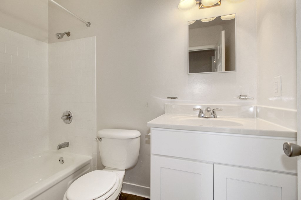 an empty bathroom with a toilet sink and tub
