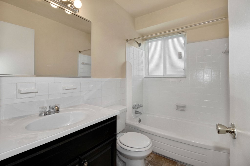 Bathroom with vanity, toilet and shower with window