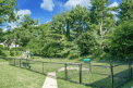 a park with a fenced in area and trees