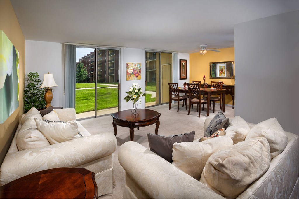 A living room with a couch, chair, and table.