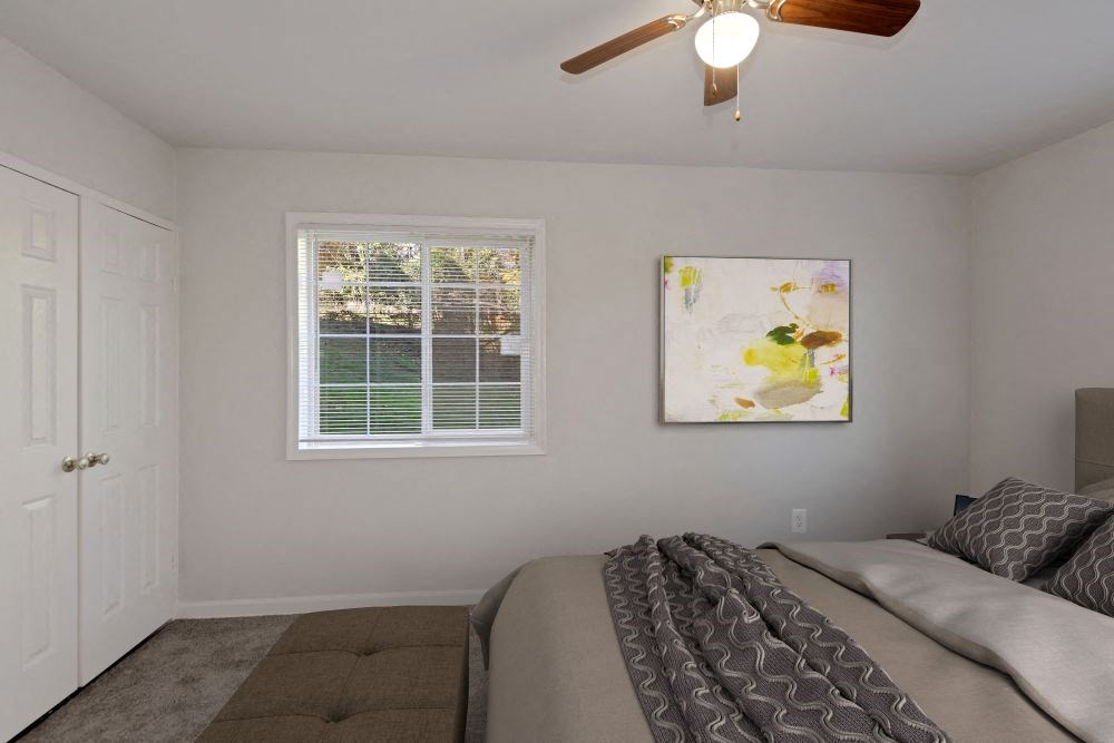 Bedroom with window, closet, ceiling fan