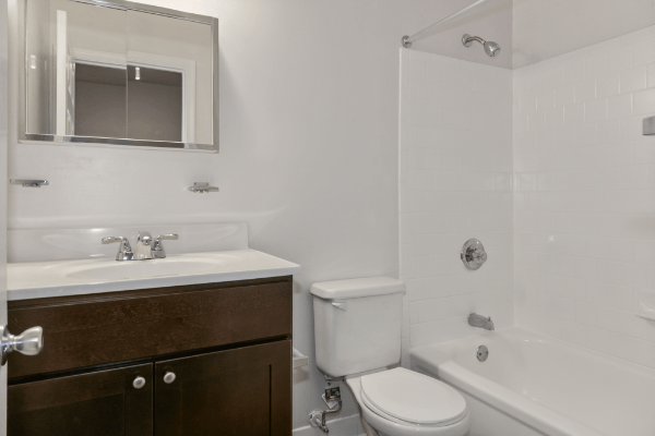 an empty bathroom with a sink toilet and shower