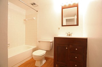 Bathroom with brown, wood vanity at The Glen Apartments in Falls Church, VA Bathroom with brown, wood vanity - Photo Gallery 4