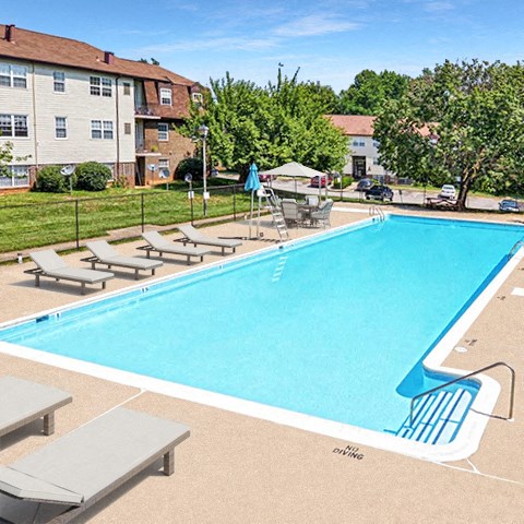 a swimming pool with chairs around it and buildings in the background