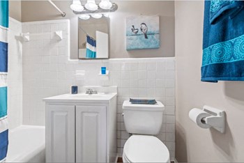 Bathroom with vanity, toilet, shower and mirror at Park Greene Apartments 2641 Shadyside Avenue 1-3 Beds Apartment for Rent - Photo Gallery 4