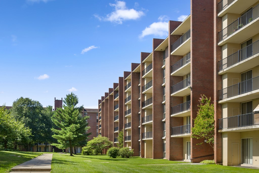 A long brick building with balconies on the side.