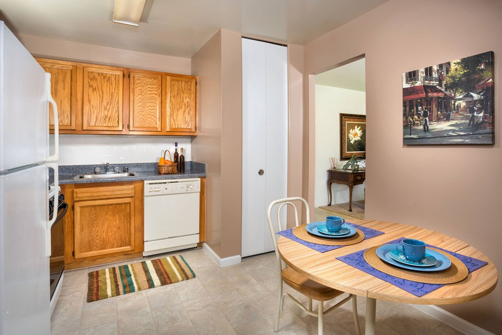 A kitchen with a table set for two.