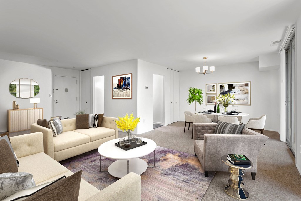 A living room with a white coffee table and a grey couch.