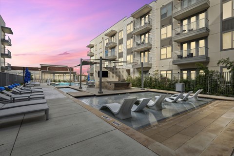 Resort style pool deck with sun loungers at LynnCora Apartments, Grand Prairie, 75052