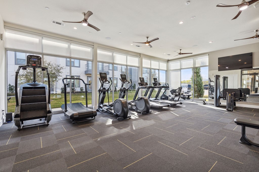 the state of the art gym is equipped with cardio equipment and floor to ceiling windows the state of the art gym is equipped with cardio equipment and floor to ceiling windows at LynnCora, Texas, 75052