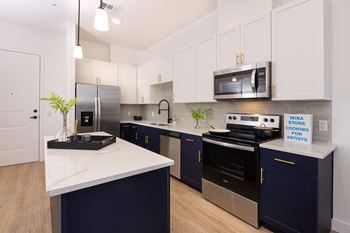 model apartment kitchen with premium stainless steel appliances