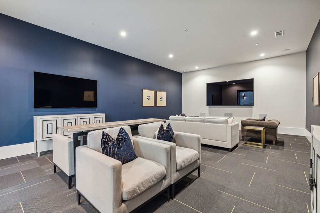 Resident lounge area with comfortable seating and large TVs on the wall at LynnCora, Grand Prairie, TX, 75052