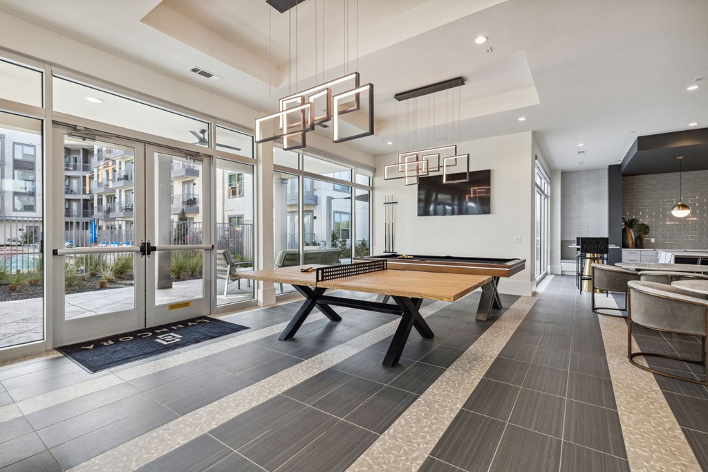 a ping pong table in a game room with glass doors at LynnCora, Texas, 75052