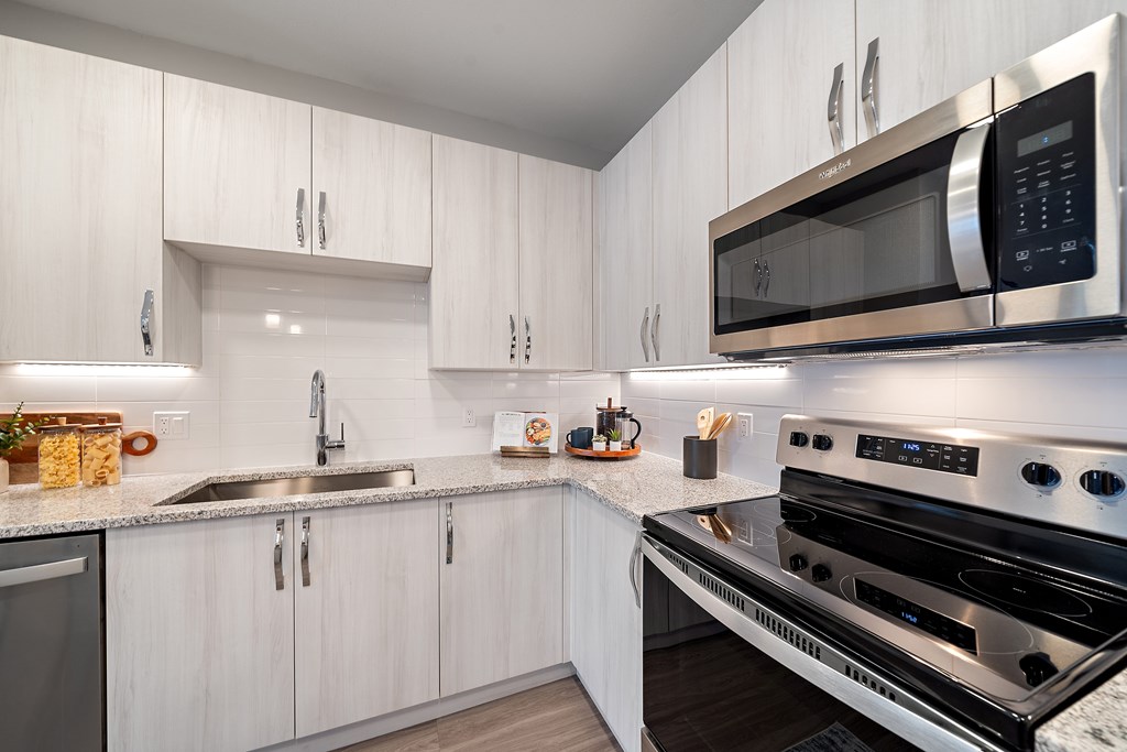 A modern kitchen with a stainless steel oven and microwave. at Mira at Palmer Ranch, Sarasota, FL