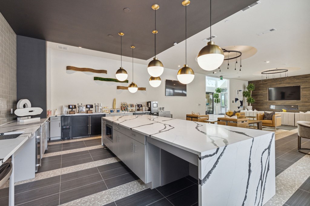 a kitchen with a large island and a dining room with chairs a kitchen with a large island and a dining room with chairs at LynnCora, Grand Prairie, 75052
