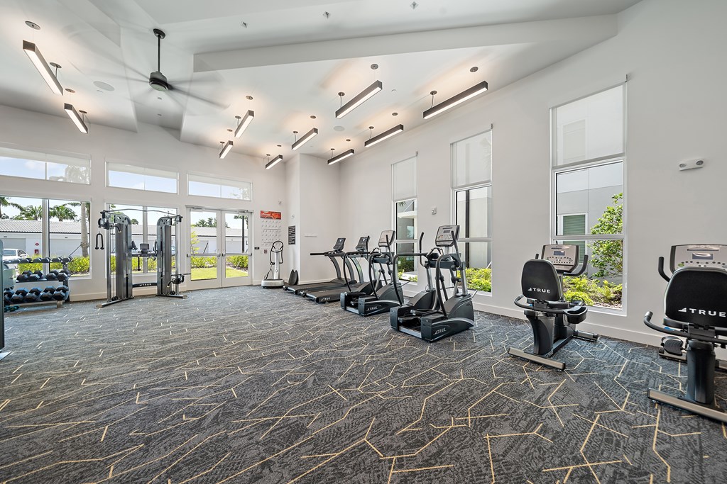 A gym with a variety of exercise equipment including treadmills, stationary bikes, and weight machines. at Mira at Palmer Ranch, Sarasota, FL, 34238