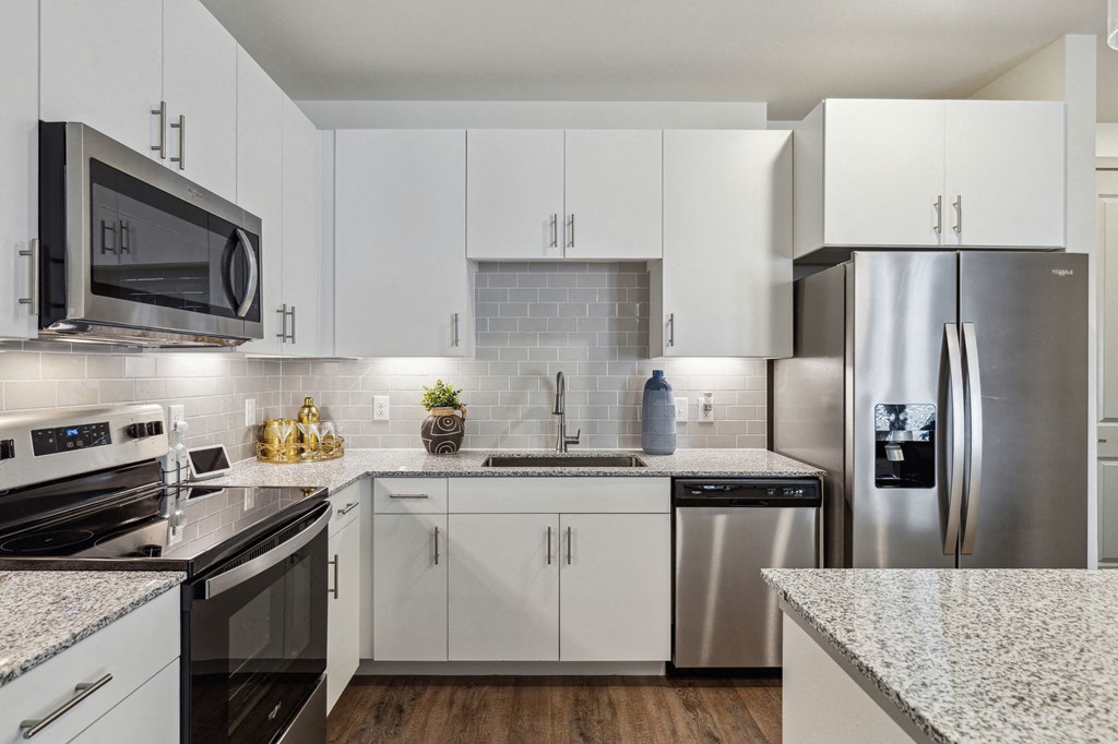 Model apartment kitchen area with stainless steel applicances at LynnCora, Grand Prairie