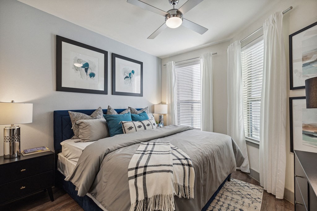 a bedroom with a large bed and a ceiling fan a bedroom with a large bed and a ceiling fan at LynnCora, Grand Prairie, Texas