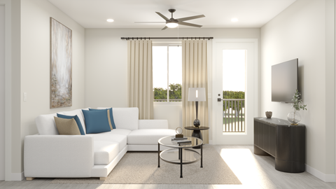 A living room with a white couch and a ceiling fan.
