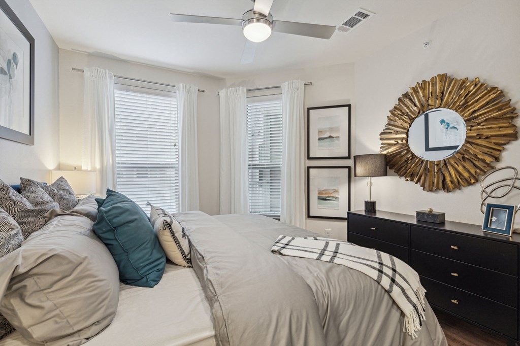 spacious bedroom with two windows and ceiling fan at LynnCora, Texas