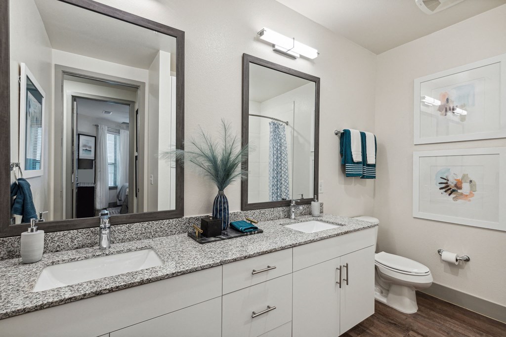 a bathroom with two sinks and a mirror and a toilet at LynnCora, Grand Prairie, TX, 75052