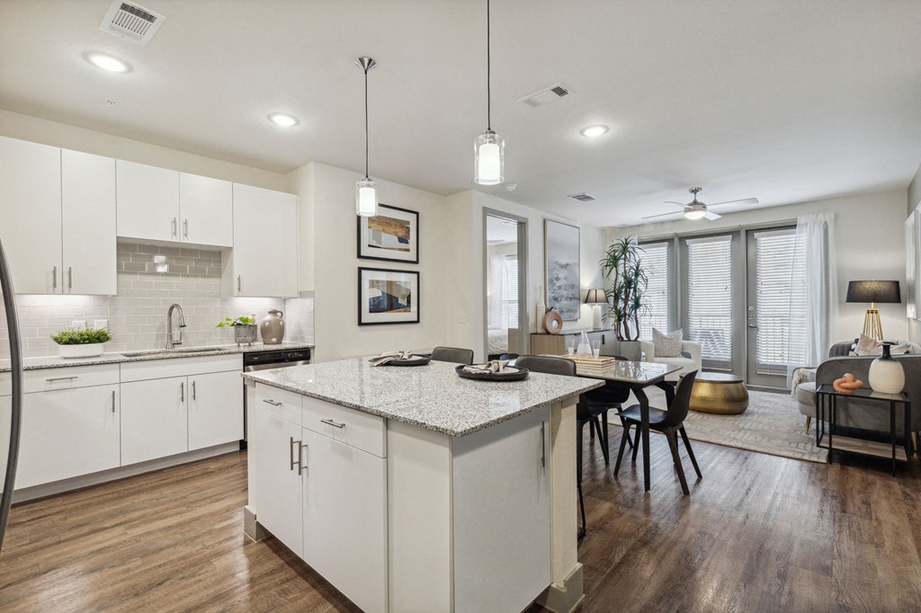 a kitchen and dining room with white cabinets and a white counter top at LynnCora, Texas, 75052