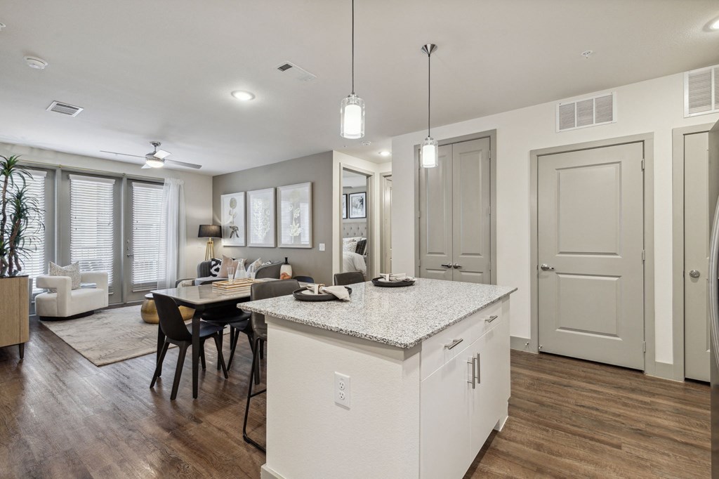 an open kitchen and dining room with a table and chairs and kitchen island at LynnCora, Texas, 75052