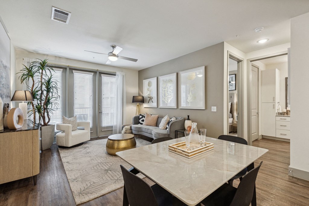 an open living room and dining room with a white table at LynnCora, Grand Prairie, TX, 75052