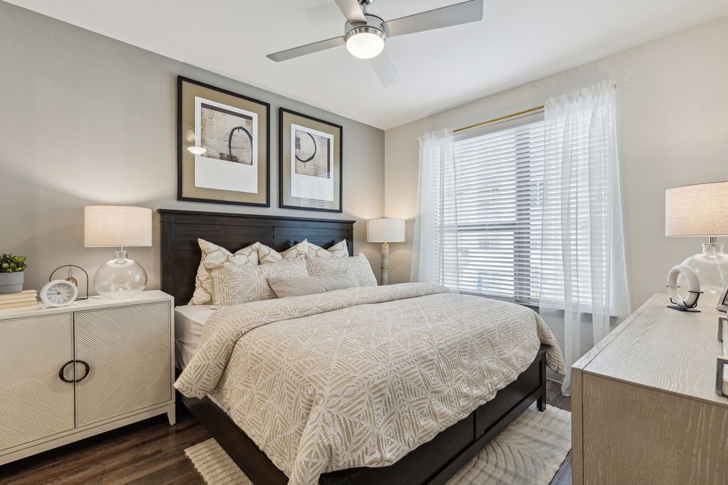 a bedroom with a bed and a ceiling fan at LynnCora, Grand Prairie, 75052