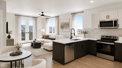 A modern kitchen with a dining table and a living room area.