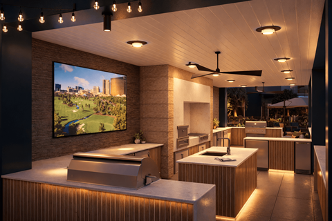 A modern kitchen with a large TV screen displaying a landscape.