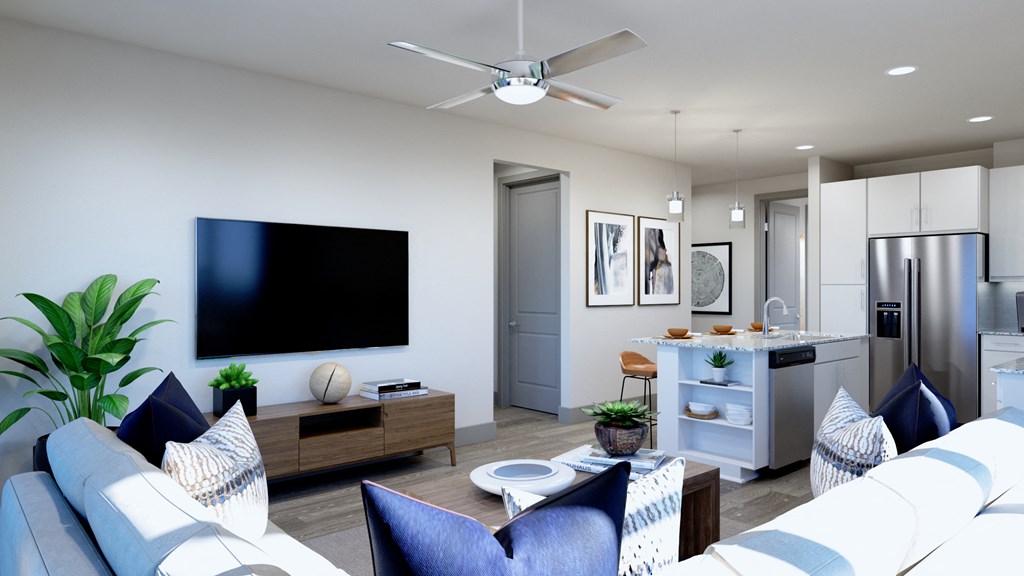 Model apartment living room and kitchen area with ceiling fan stainless steel appliances at Ironcrest, North Richland Hills, Texas