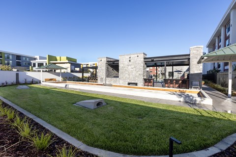 A modern building with a Bocce Court in front