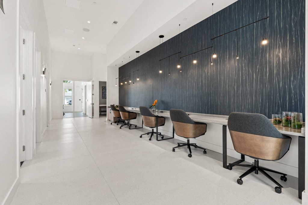 a reception area with chairs and a long table