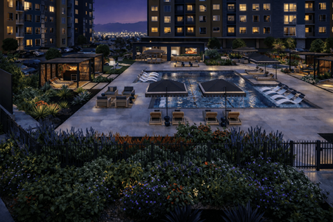 Resort style pool deck with cabanas at twilight at Avela Luxury Apartments, Henderson