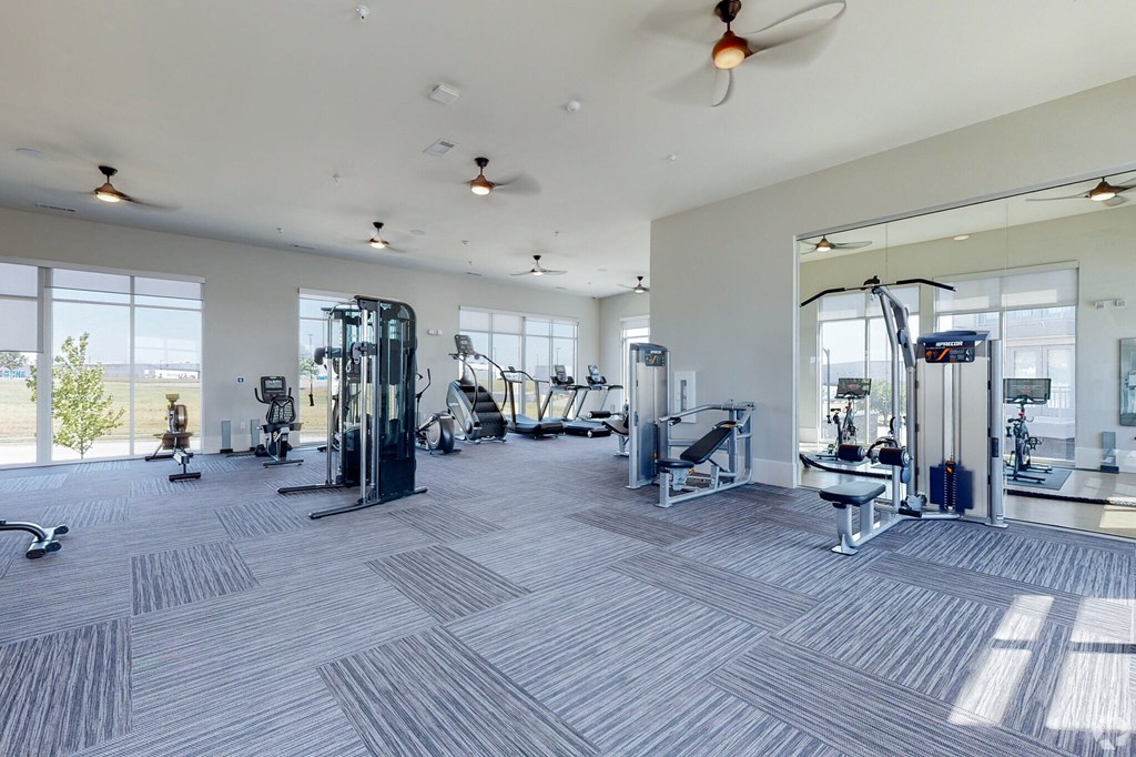 Ironcrest apartments spacious fitness center with cardio equipment and large windows