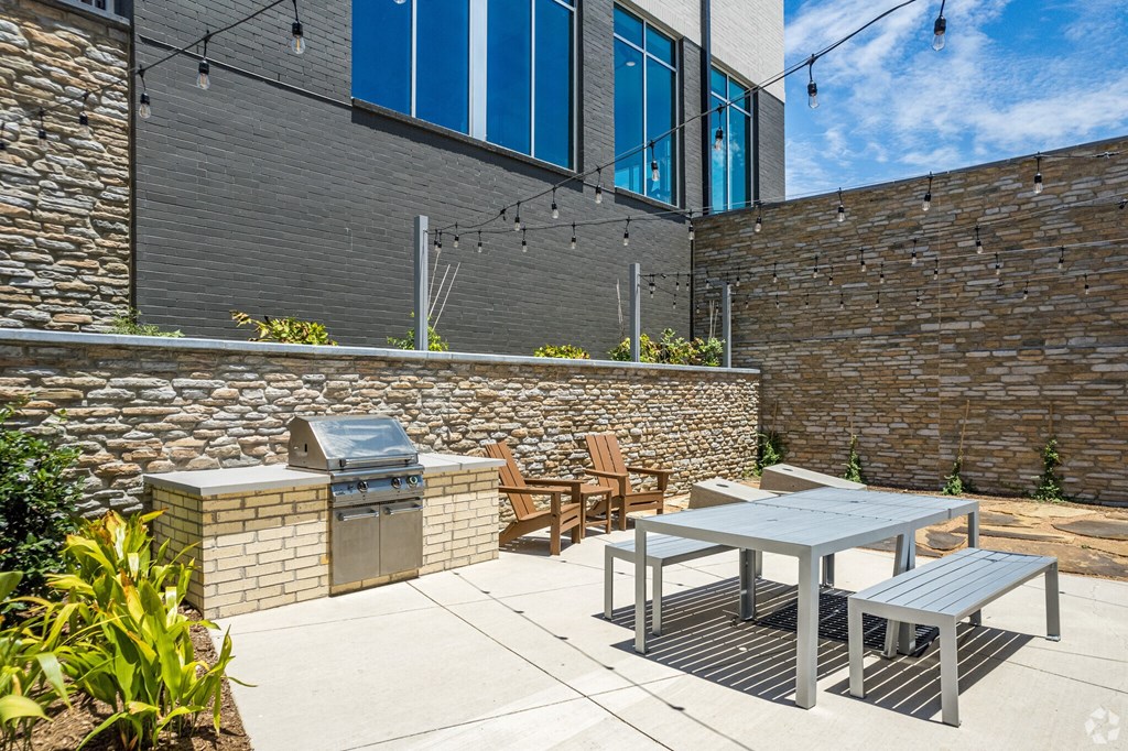 outdoor patio with a grill and tables and chairs Ironcrest